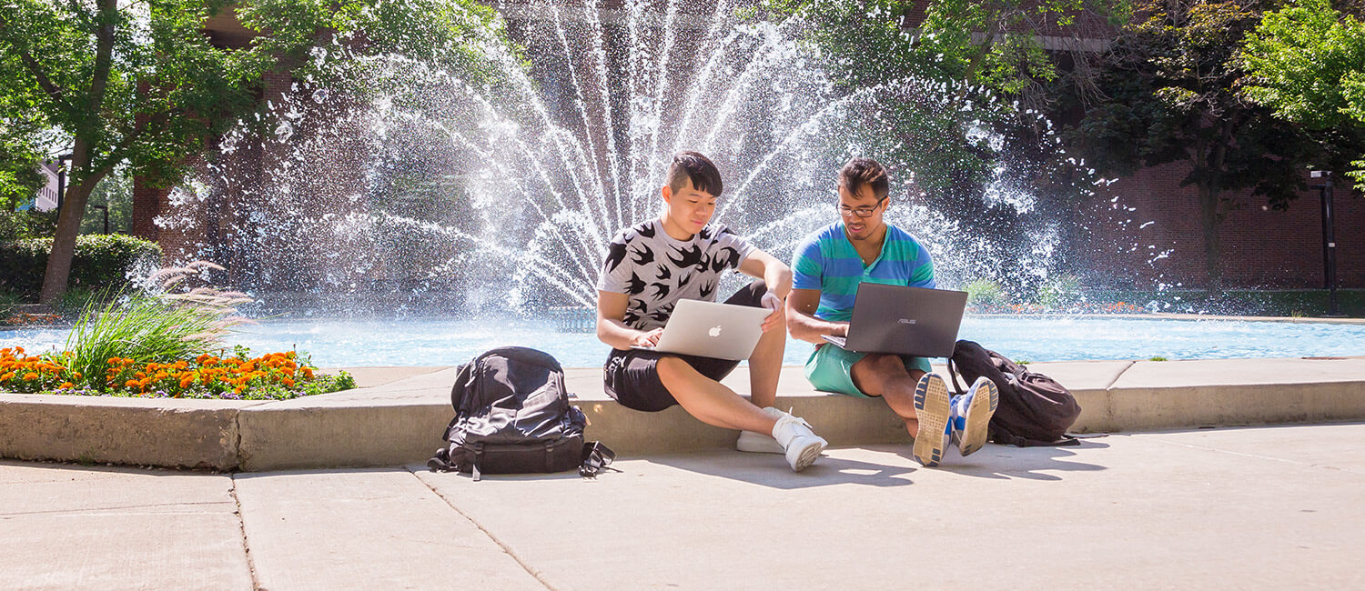 Students sitting near the fountain in the Ernest Spaights Plaza
