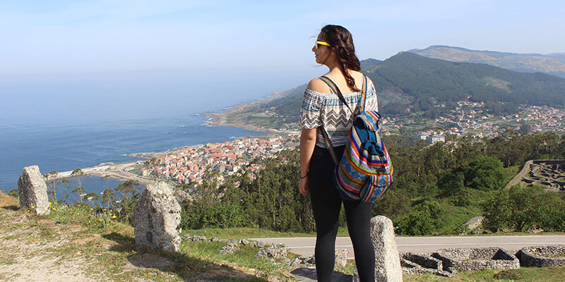Student on a hill overlooking the ocean in Spain