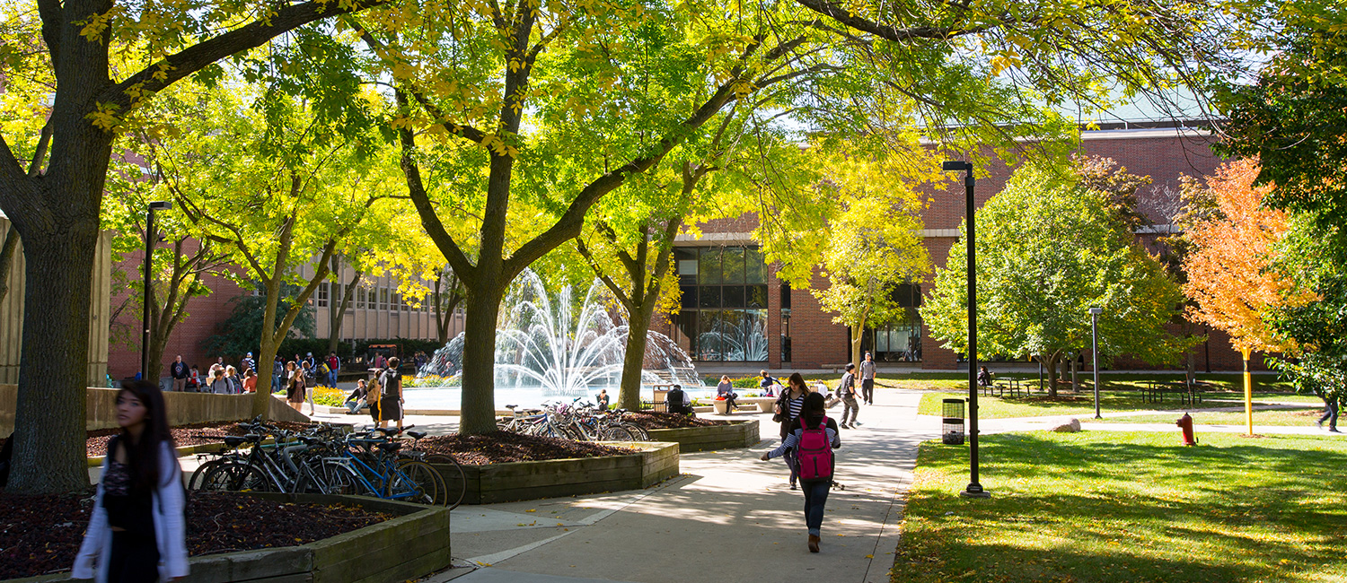 Students walking around campus near the UWM fountain
