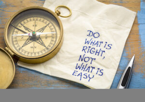 Compass on top of napkin that reads: do what is right, not what is easy