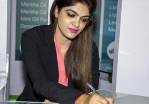 Woman wearing business attire and writing with a pen