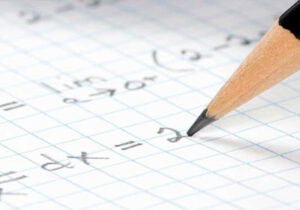 Pencil writing a mathematical equation