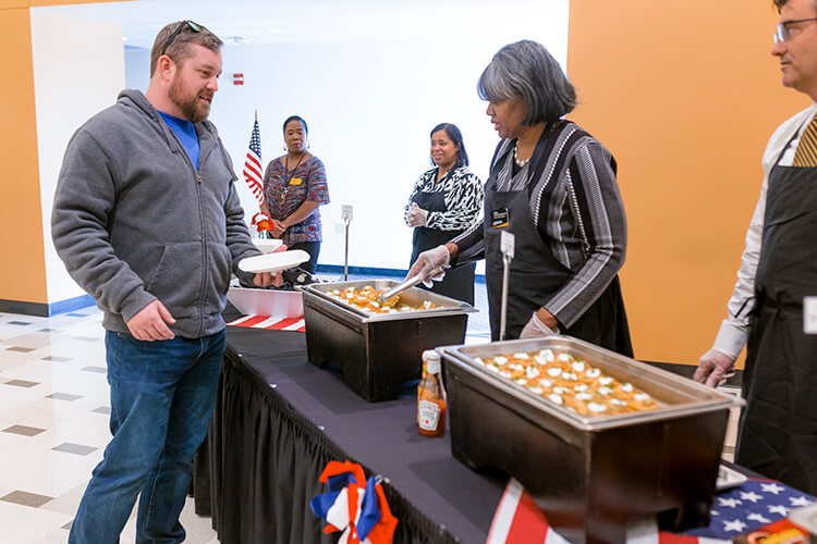 Student Sean Bante, who served in both the U.S. Army and Air Force, is served a frittata.