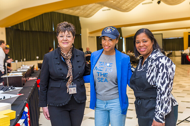 Milwaukee VA Regional Office representative Gretchen Schuttey (left) and Ramona Sledge (right), an adviser at the Black Student Union, greet Saprina Johnson, a corporate partner liaison/public relations officer at Student Veterans of America-UWM Chapter, at the brunch. Sledge is a Navy veteran.