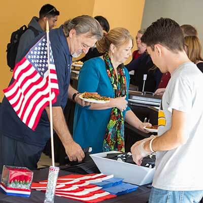 Students serving veterans at an event