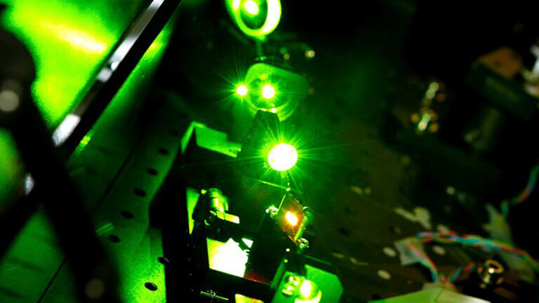 Close up of a machine with a bright green light