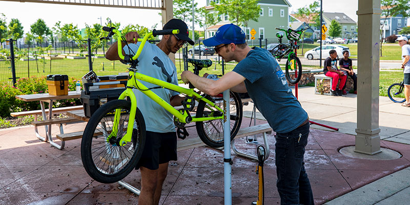 Two UWM students repair a bike