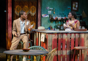 Stage production with two Black actors - one at a bar and one behind it