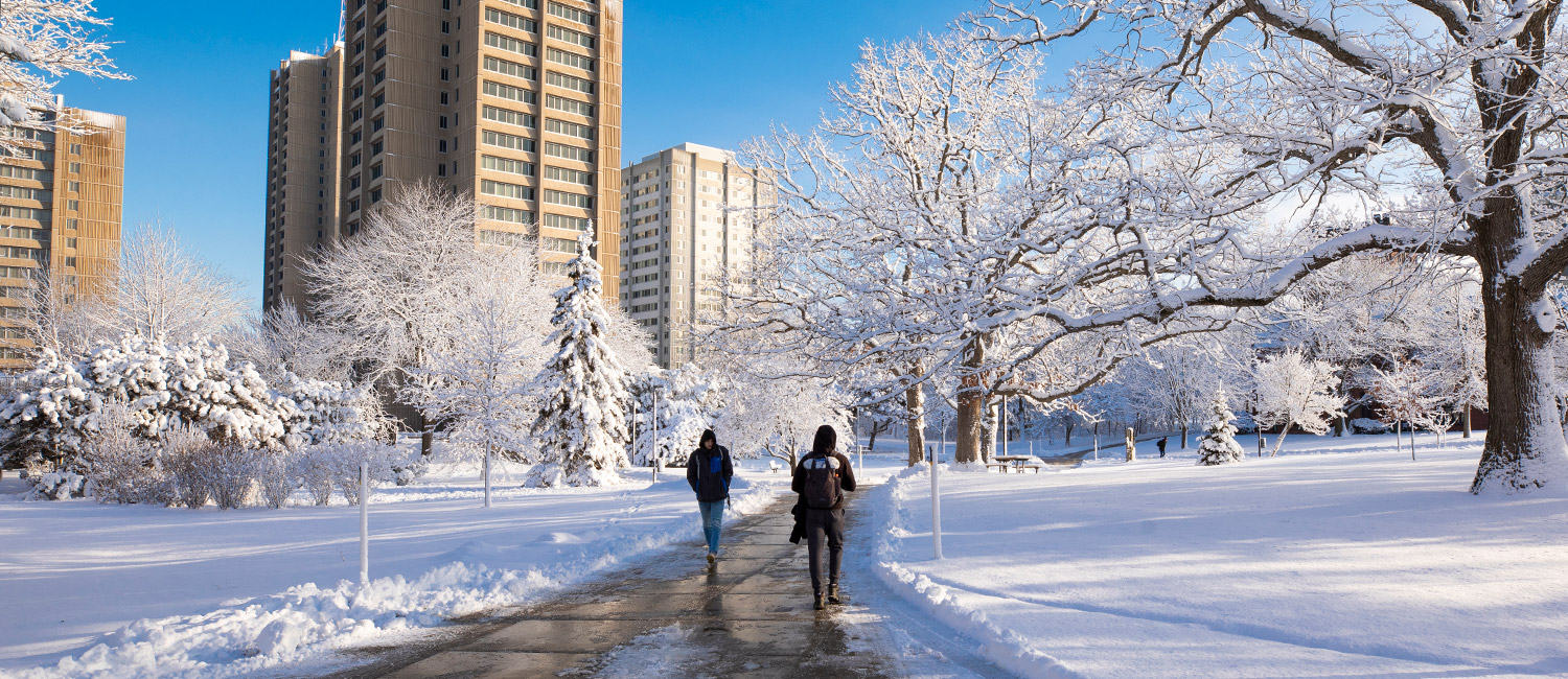 Students walking through the snowy UWM campus