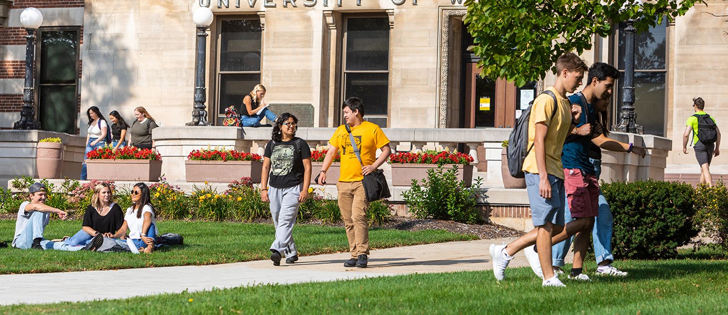 UWM students walking across a bustling campus