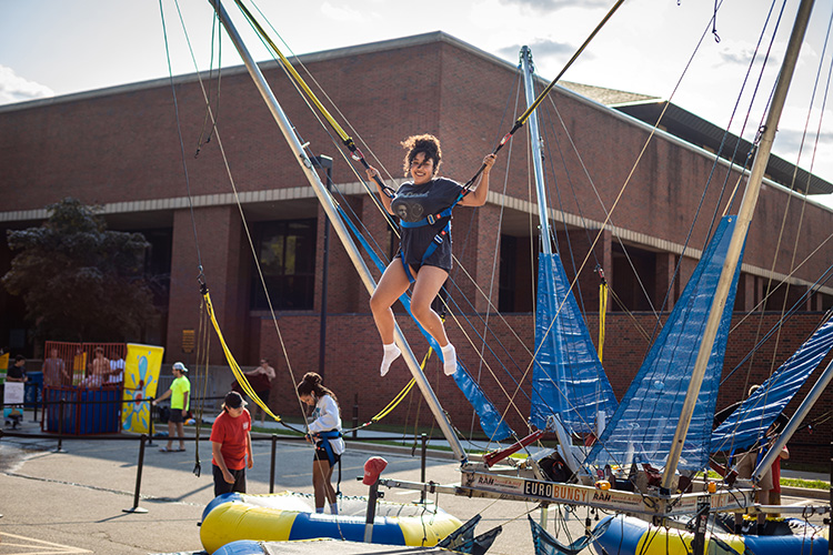 UWM student in a bungee trampoline jump during UWM Fall Welcome