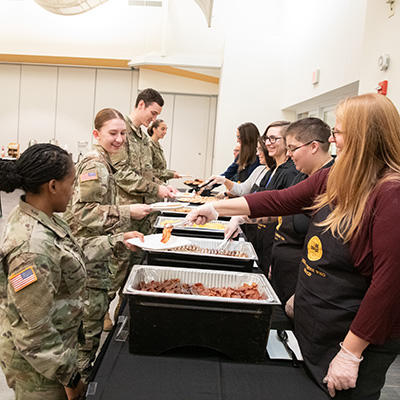 Service members being served brunch at UWM