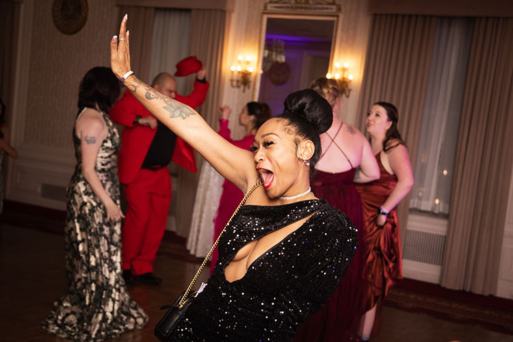 UWM student dancing at annual veterans ball in sequined dress