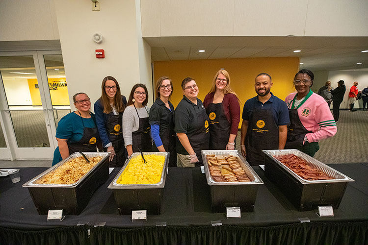 UWM employees standing in a row to serve veterans brunch