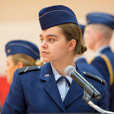 ROTC student standing in front of a microphone