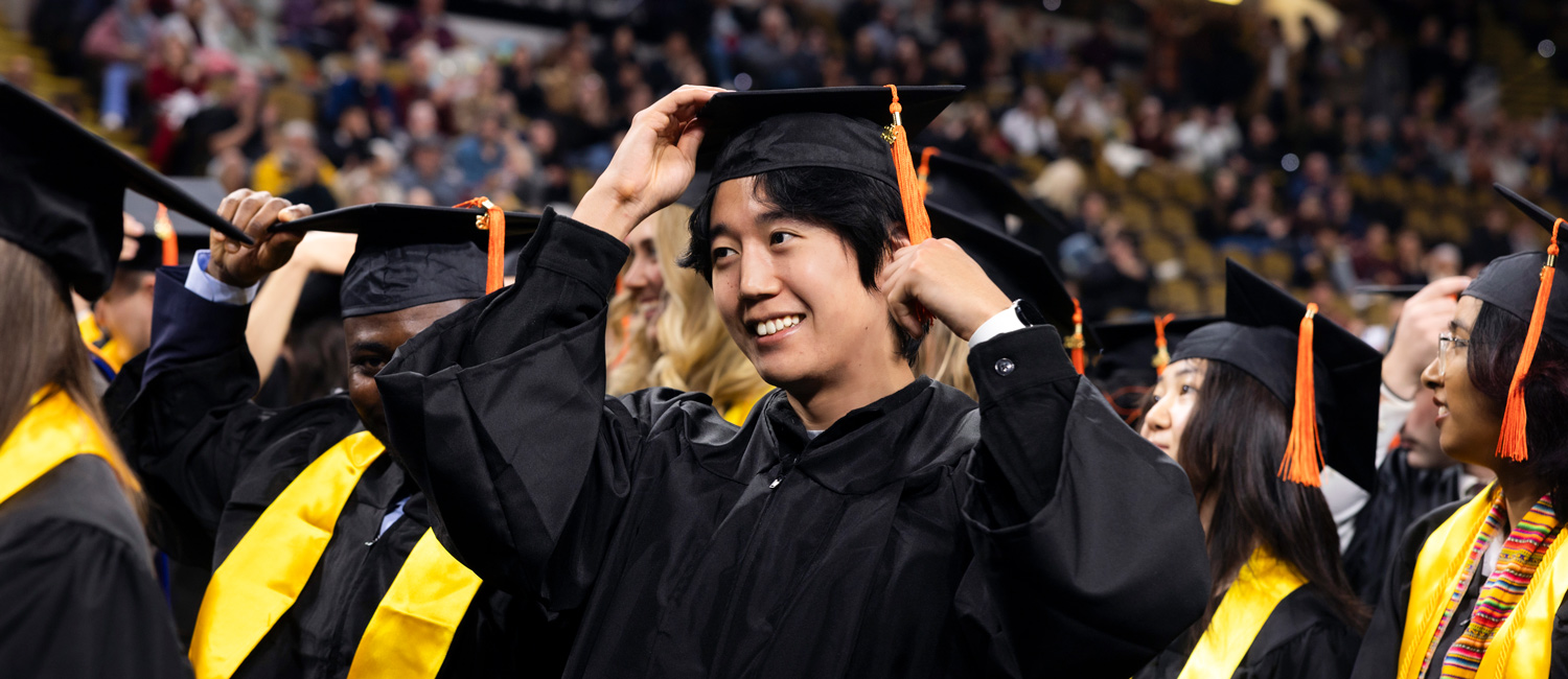 Student smiles proudly at UWM's Fall 2025 Commencement Ceremony