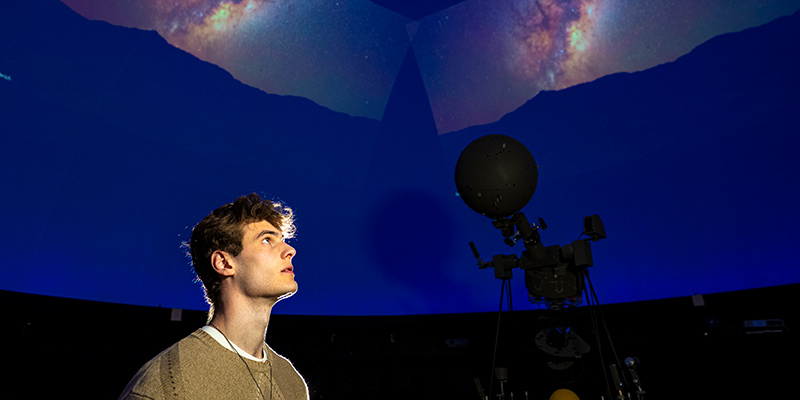 Ben Lorenz, a UWM student looking up at the Planetarium sky