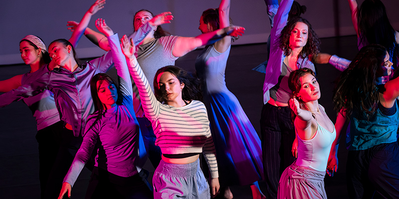 UWM student dancers performing on stage.